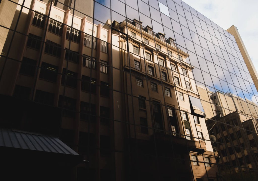 photo of a building reflecting in another building