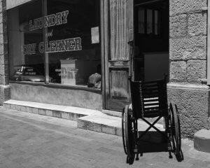 Photo of a wheel chair outside a laundromat
